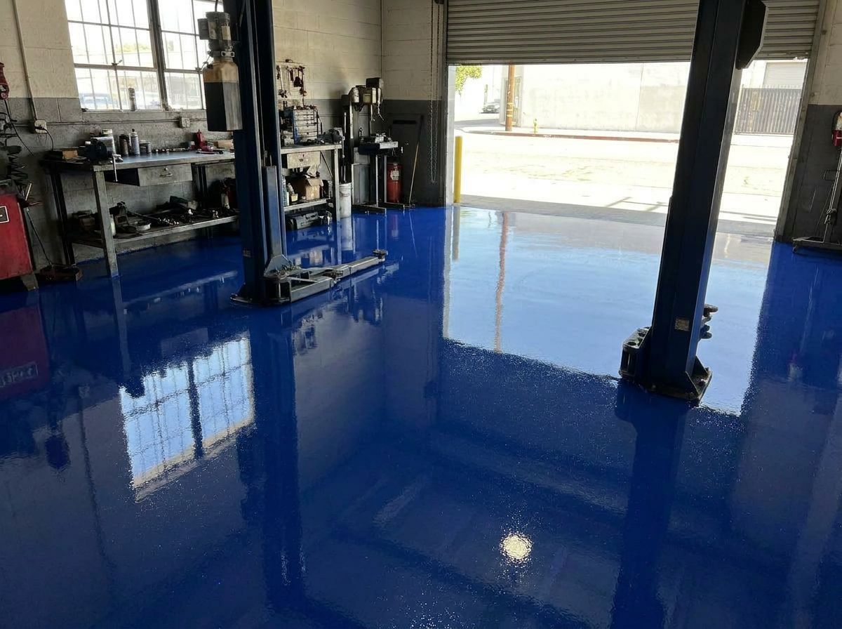 Same auto shop bay with deep blue high-gloss epoxy floor